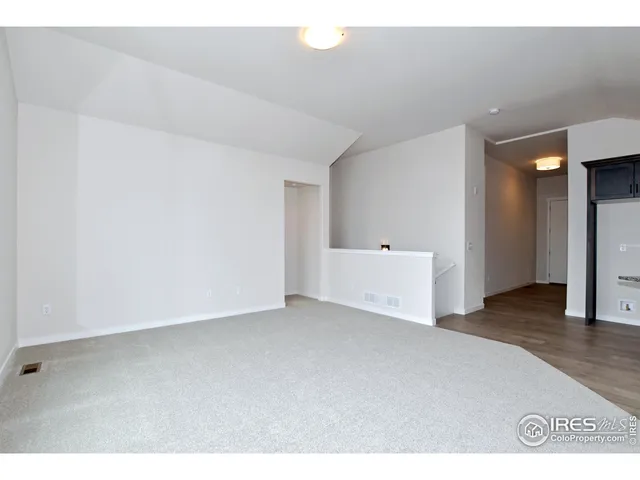 a view of wooden floor and windows in a room