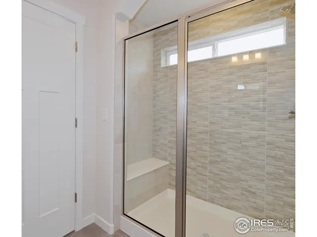 a bathroom with a glass shower door