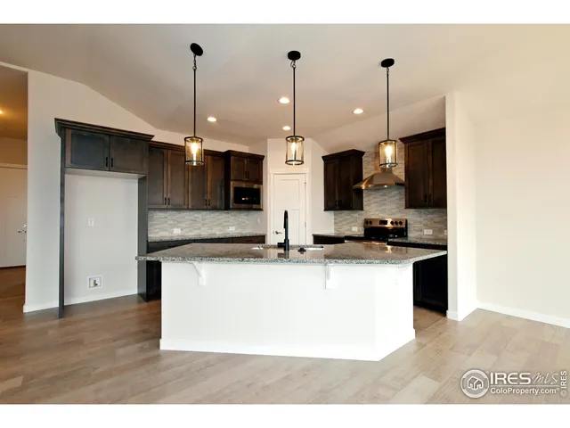 a large kitchen with stainless steel appliances kitchen island a large island in the center