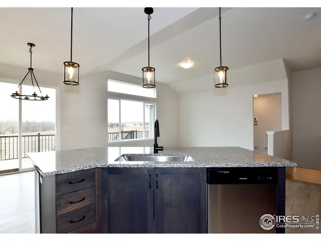 a bathroom with a granite countertop sink and a large mirror
