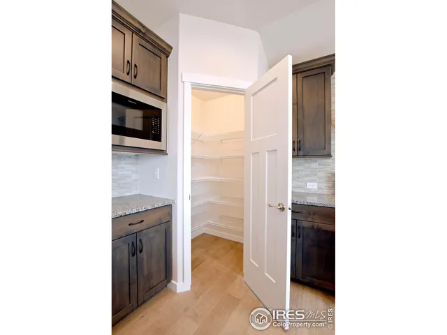 a kitchen with kitchen island granite countertop a sink stainless steel appliances and cabinets
