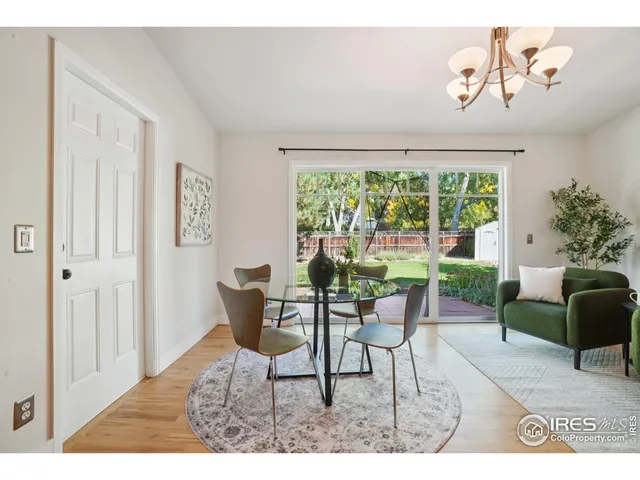 a dining room with furniture and a window