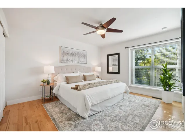 a living room with a bed furniture and a large window