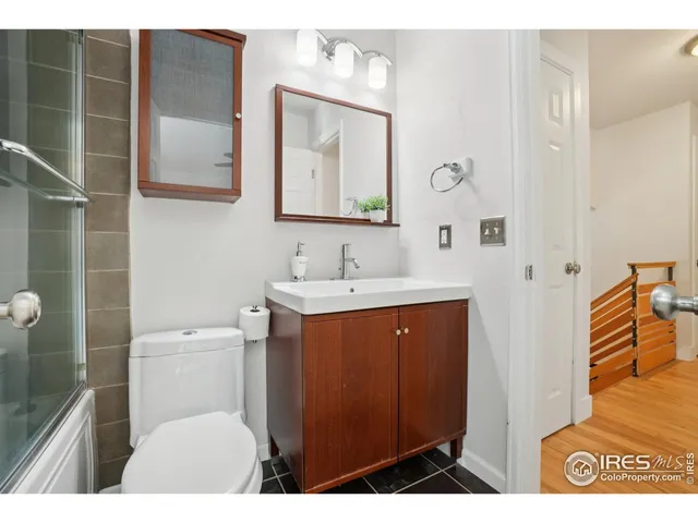 a bathroom with a toilet a sink and mirror