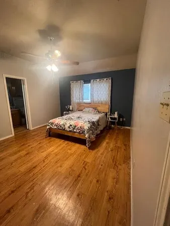 a bedroom with a bed and a window