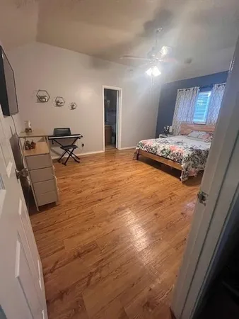 a bedroom with a bed and wooden floor