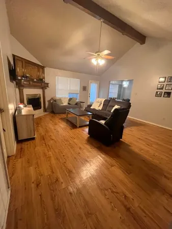 a living room with furniture and a fireplace