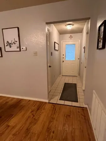 a view of a hallway view with wooden floor and staircase