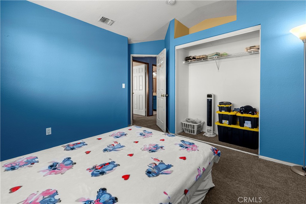 15417 Tobarra Road Fontana, CA 92337 - Photo 18 of 29 a bedroom with a bed and a dresser