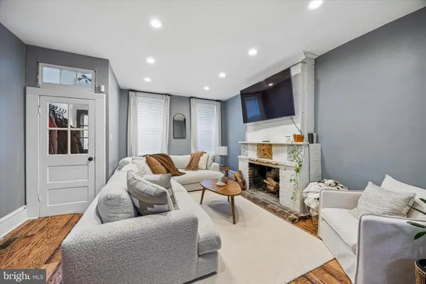 a living room with furniture a fireplace and a flat screen tv