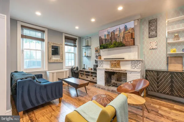 a living room with furniture fireplace and a flat screen tv
