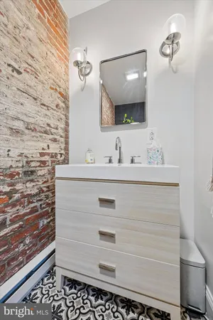 a bathroom with a sink vanity and a mirror