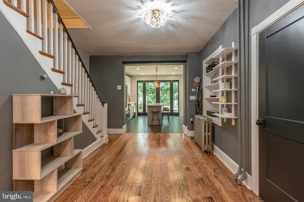 a view of a hallway with wooden floor and staircase