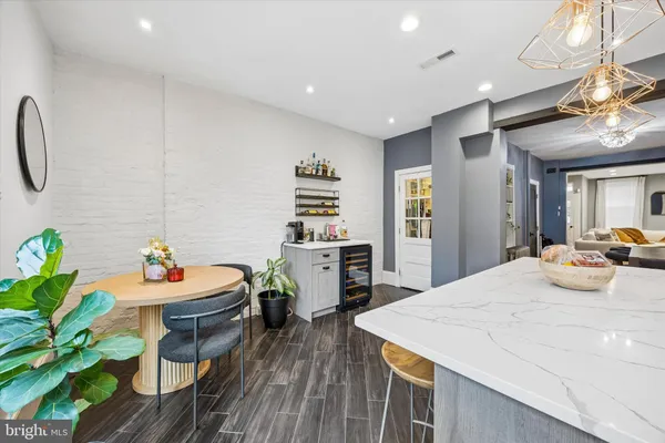 a dining room with stainless steel appliances kitchen island granite countertop furniture and a kitchen view