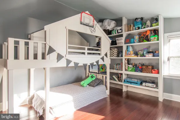 a living room with furniture and a book shelf