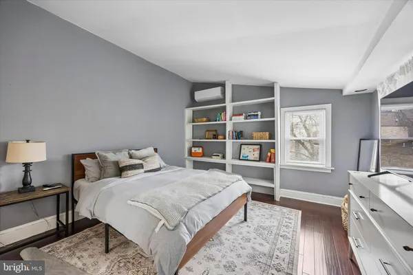 a bedroom with a bed and a book shelf