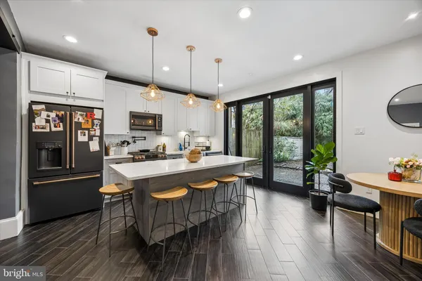 a large kitchen with a table and chairs