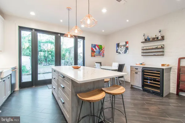 a living room with stainless steel appliances furniture and a large window