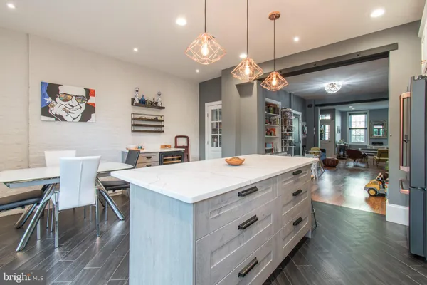 a large kitchen with a table and chairs