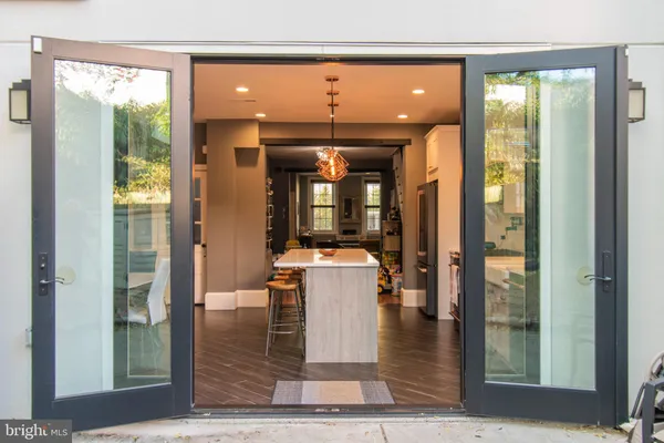 a very nice looking dining room with wooden floor and a floor to ceiling window