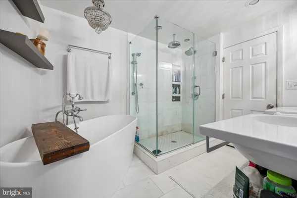 a bathroom with a tub shower and sink