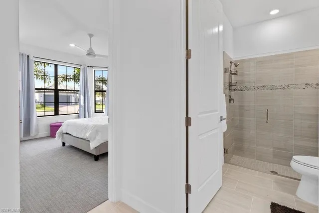 a spacious bedroom with a bed and a couch