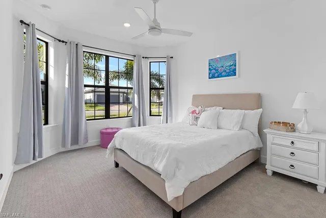 a bed room with a bed and a large window