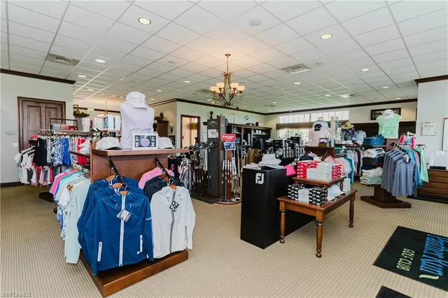a dining room with furniture water view and a floor to ceiling window