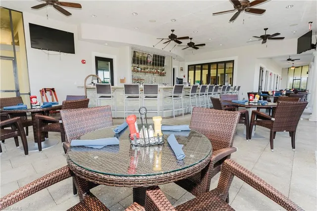 a kitchen with a sink stove and chairs