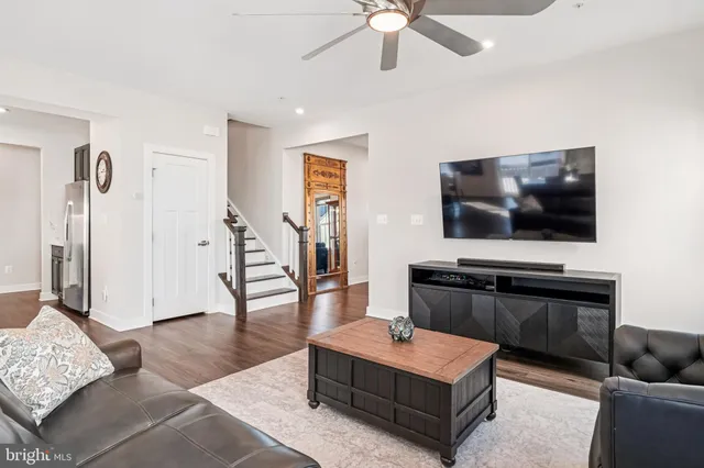 a view of a kitchen area with furniture and wooden floor