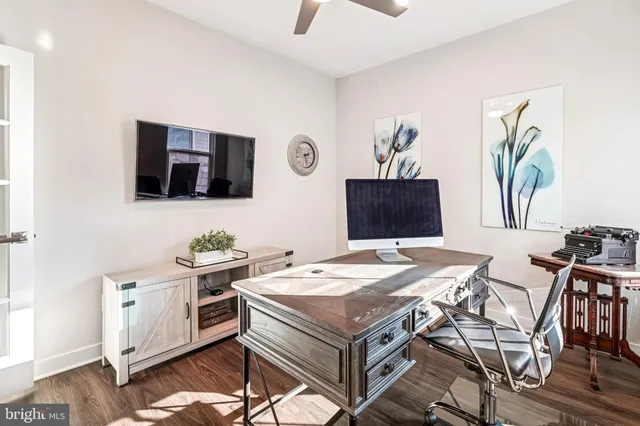 a view of a workspace with furniture and a window