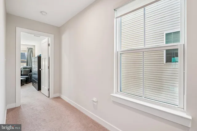 a bedroom with a bed couch and window