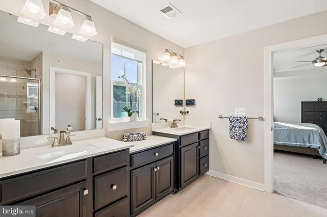 a bathroom with a double vanity sink mirror and double