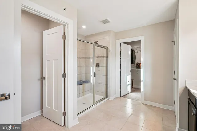 a bathroom with a glass shower door