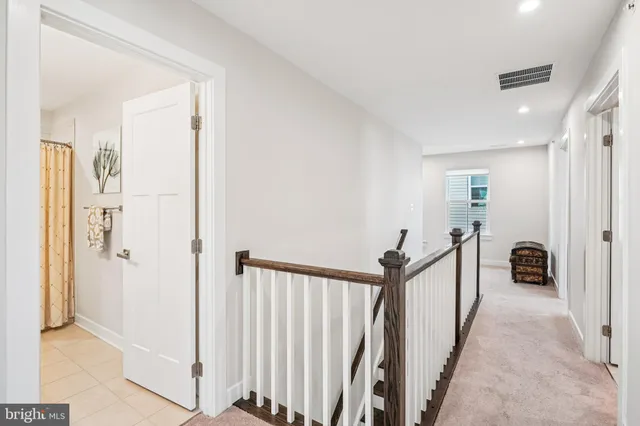 a bedroom with a bed and a ceiling fan