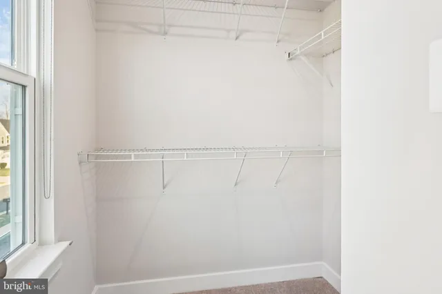 a view of hallway with stairs and wooden floor