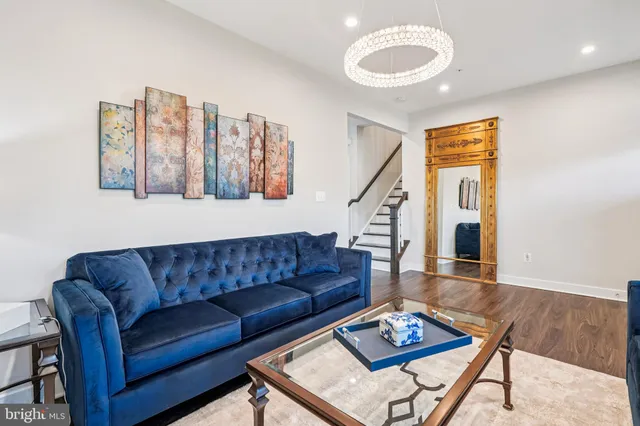 a kitchen with stainless steel appliances granite countertop wooden floor a dining table and chairs