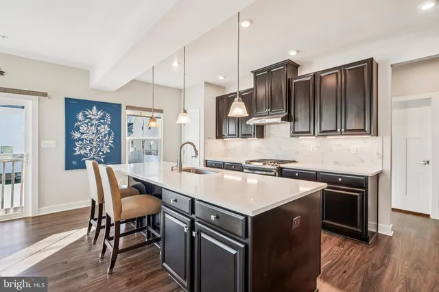 a large kitchen with a stove and a large window