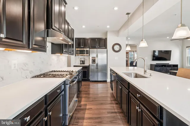 a kitchen with a table chairs refrigerator and microwave
