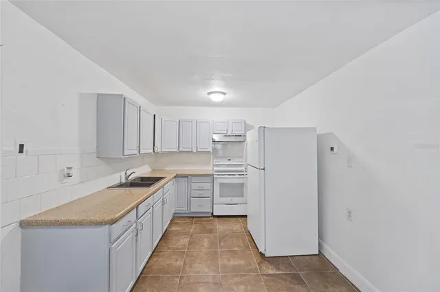 a kitchen with a sink a stove and refrigerator