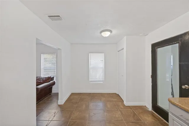 a view of a hallway to rooms and stairs