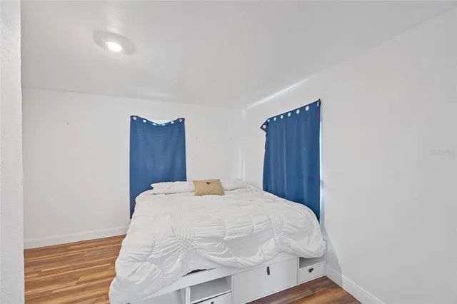 a bed sitting in a bedroom chandelier