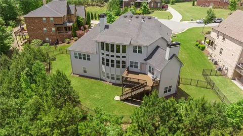 a kitchen with stainless steel appliances a stove a sink dishwasher a refrigerator and white cabinets with wooden floor