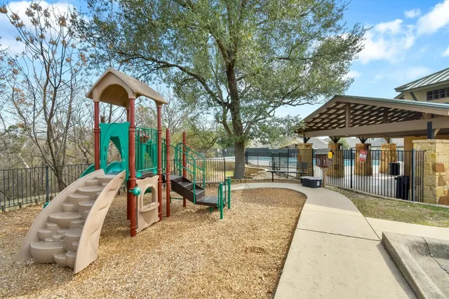 a view of a backyard with a fence