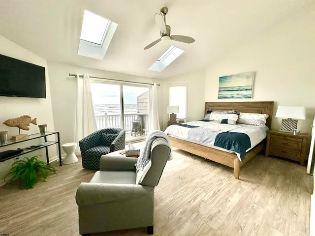 a bedroom with a bed couch and window