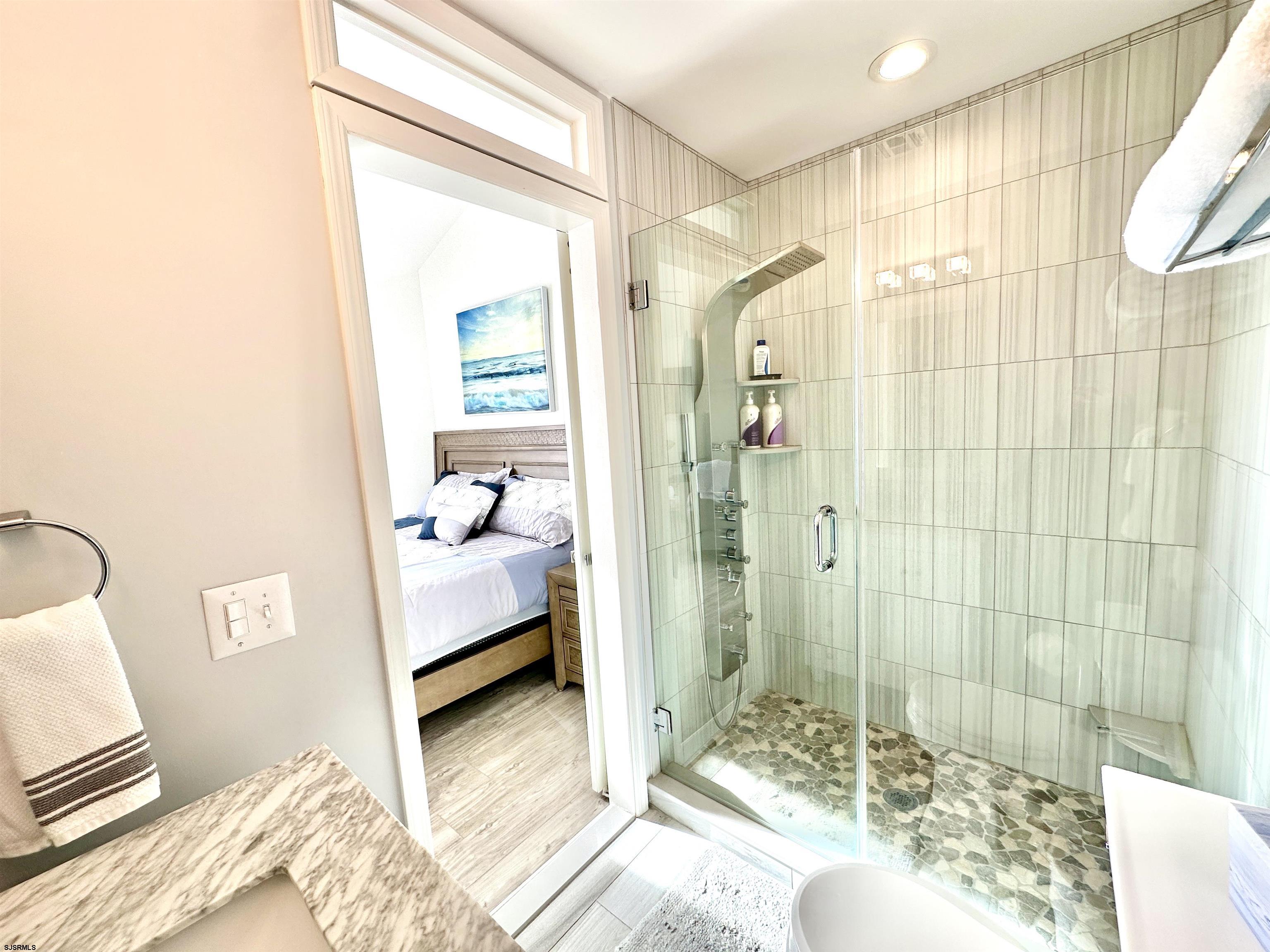 612 East Brigantine Avenue, Unit 612 Brigantine, NJ 08203 - Photo 17 of 29 a bedroom with a bed and a couch