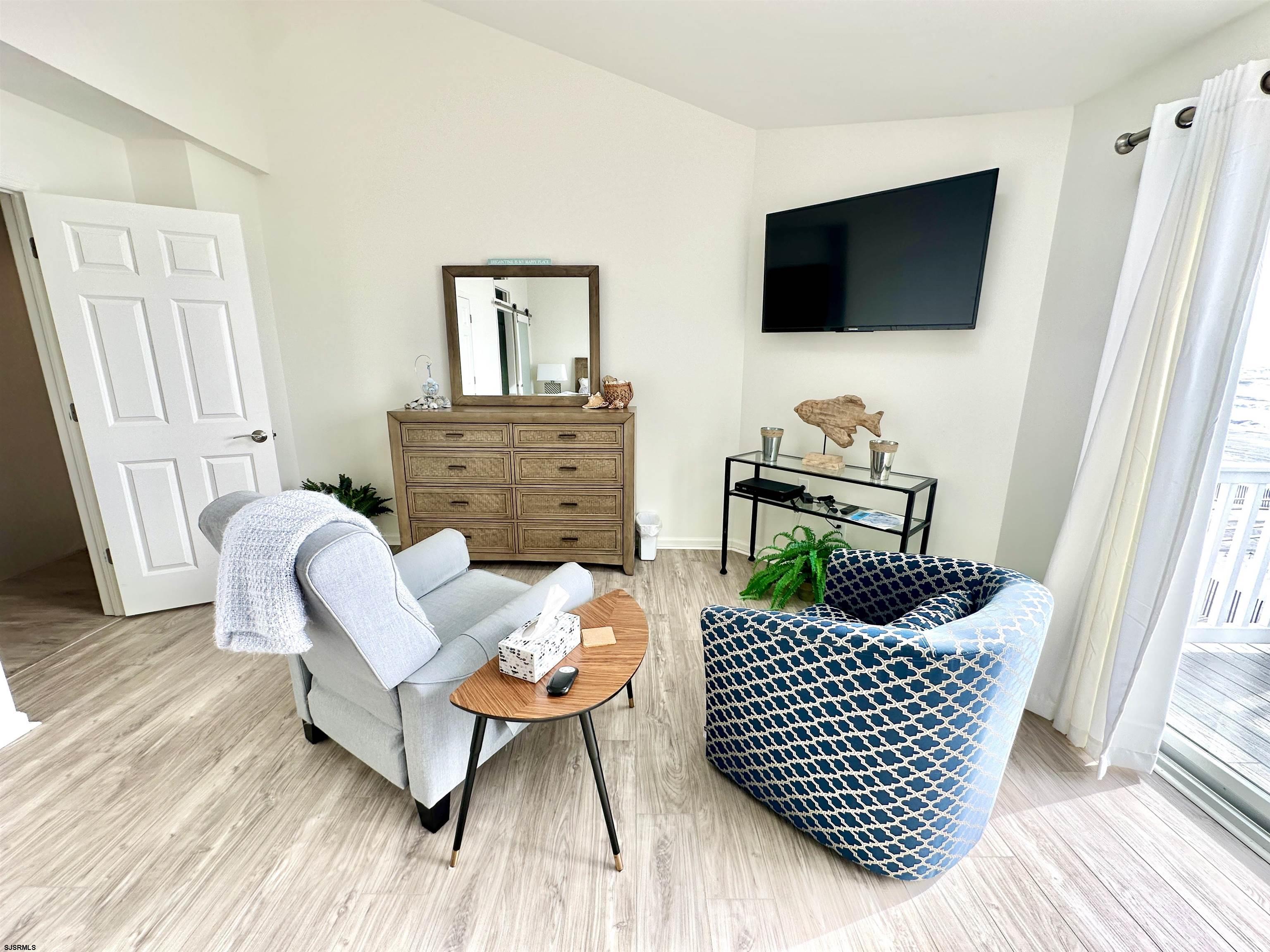 612 East Brigantine Avenue, Unit 612 Brigantine, NJ 08203 - Photo 19 of 29 a living room with furniture and a flat screen tv