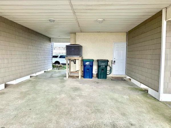 a kitchen with a sink a refrigerator a microwave and cabinets