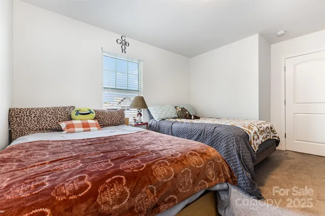 a bedroom with two beds and a window