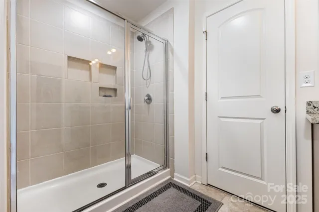 a bathroom with a glass shower door